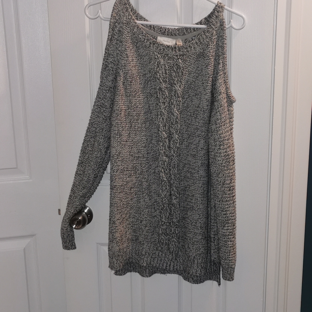 Long sweater with long sleeves and shoulder cut out. Size medium!